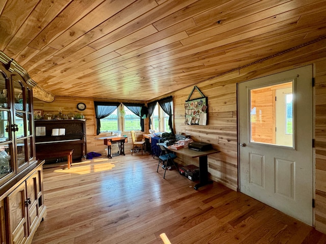 entrance foyer featuring wood ceiling, wooden walls, and light hardwood / wood-style flooring