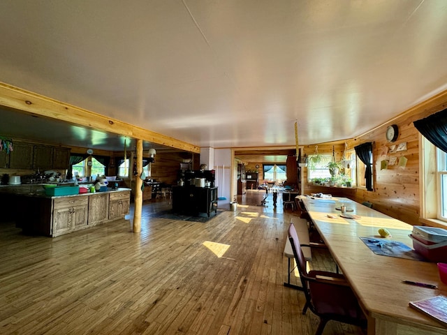 dining area featuring wood-type flooring and wood walls