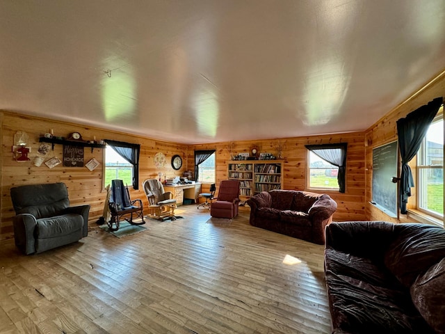 living room with wooden walls and hardwood / wood-style flooring