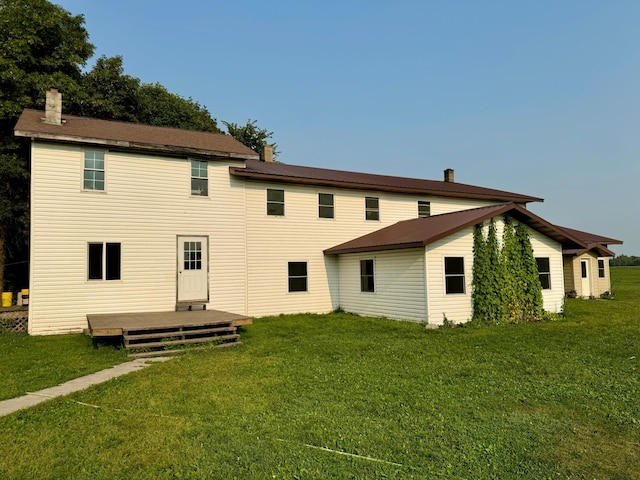 back of house featuring a deck and a yard