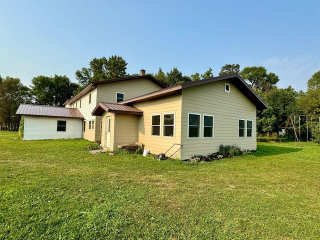 back of property featuring a yard