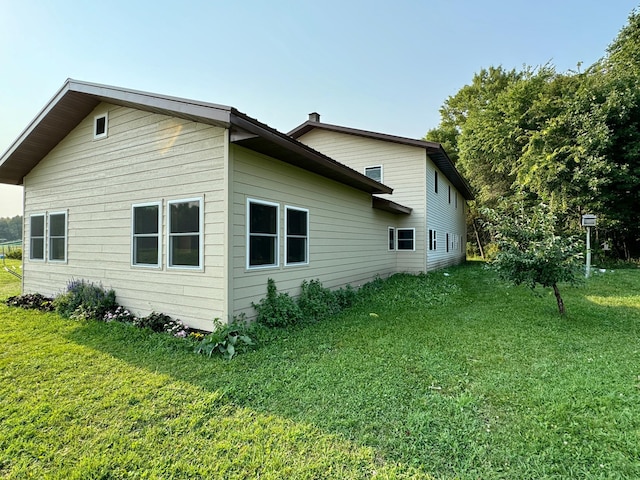 view of property exterior featuring a lawn