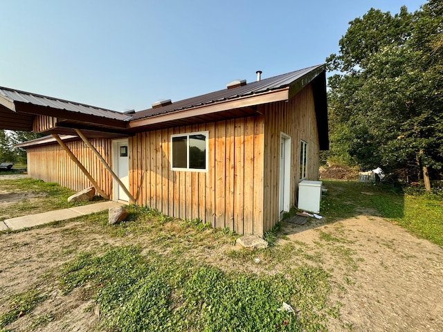 view of side of home with a yard