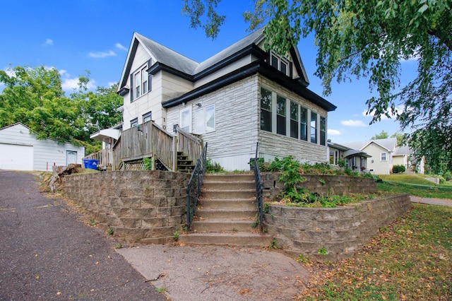 view of property exterior with an outdoor structure and a garage