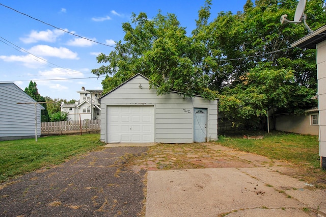 garage featuring a lawn