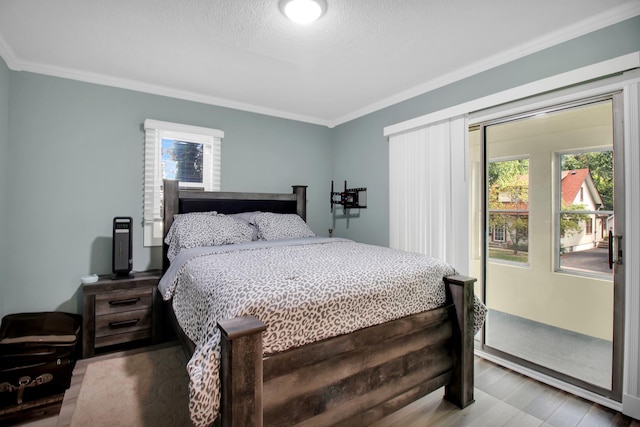 bedroom featuring ornamental molding, a textured ceiling, and hardwood / wood-style floors