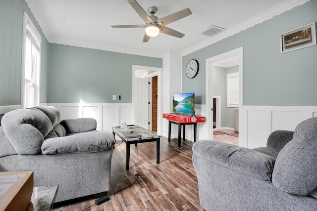 living room with ceiling fan, hardwood / wood-style flooring, and crown molding