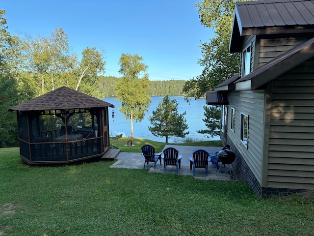 view of yard with a water view, a patio area, and a gazebo