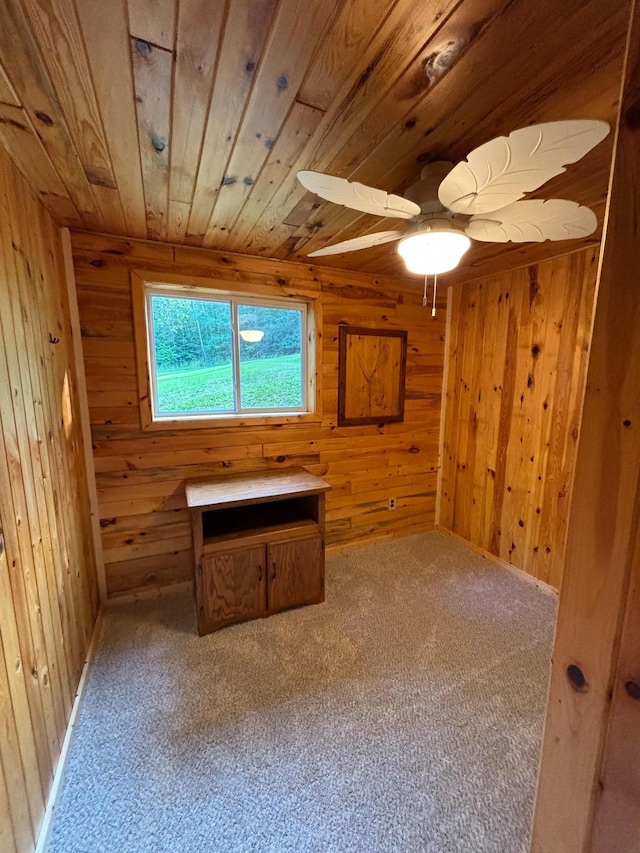 interior space with wood ceiling, wood walls, ceiling fan, and carpet floors