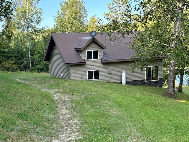 view of home's exterior with a yard