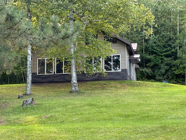 view of home's exterior with a lawn