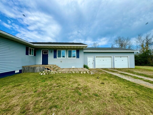 view of front of home with a front yard and a garage