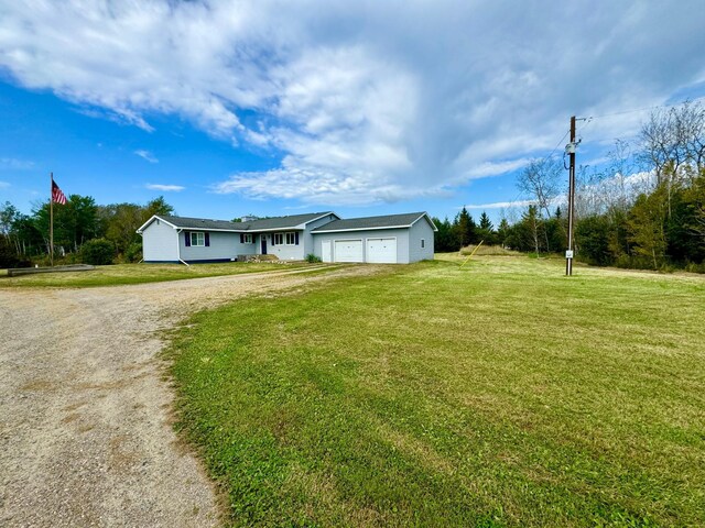 ranch-style house with a front yard and a garage