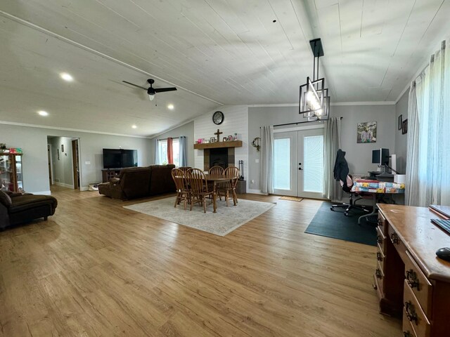 dining area featuring a wealth of natural light, lofted ceiling, french doors, and light hardwood / wood-style floors