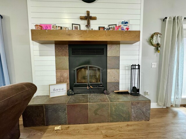 room details featuring a fireplace and hardwood / wood-style floors