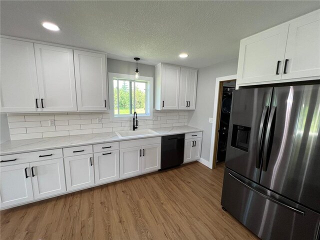 kitchen with stainless steel fridge with ice dispenser, white cabinets, sink, and dishwasher