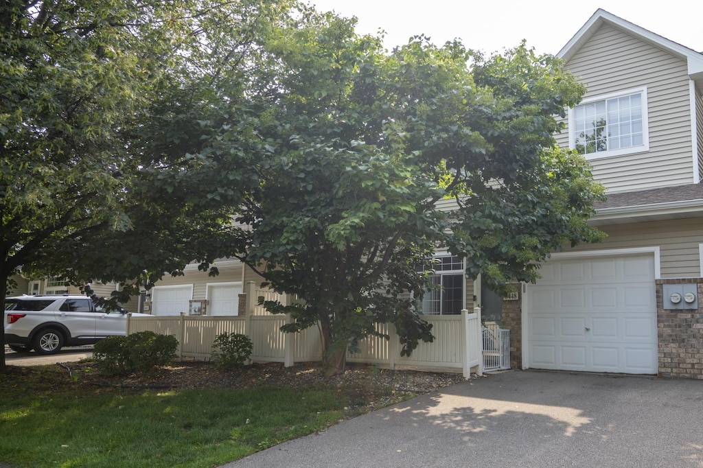 obstructed view of property with a garage