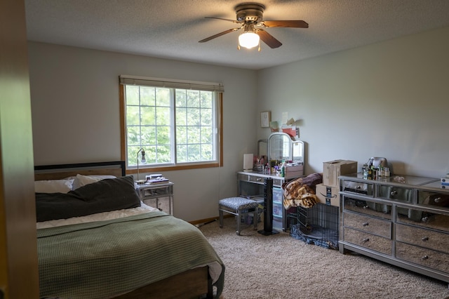 carpeted bedroom with a textured ceiling and ceiling fan