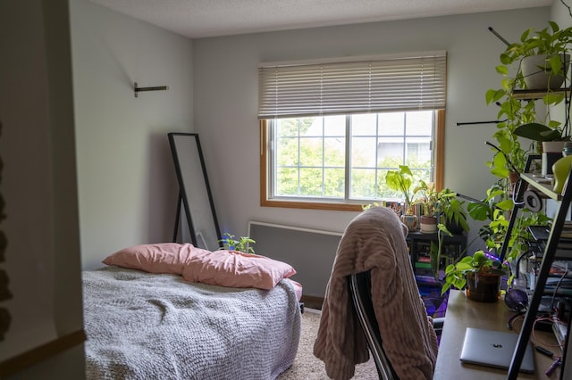 carpeted bedroom featuring a textured ceiling