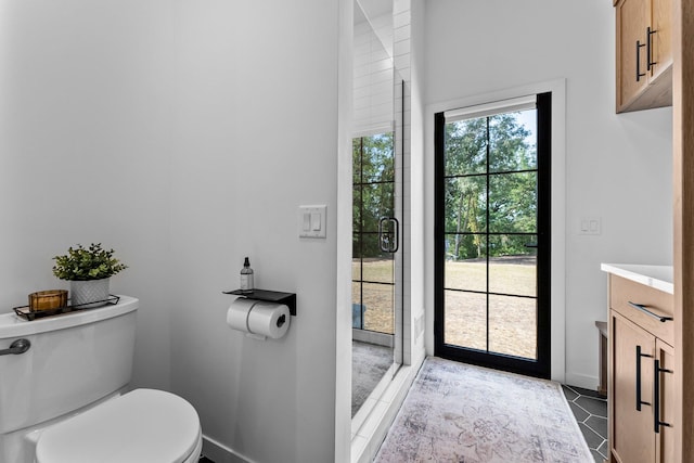 21236 Crescent Curv, Credit River Twp, MN 55044 - bathroom with toilet, a stall shower, vanity, baseboards, and tile patterned flooring