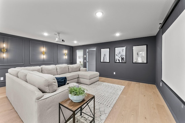 21236 Crescent Curv, Credit River Twp, MN 55044 - cinema featuring a decorative wall, light wood-style floors, and recessed lighting