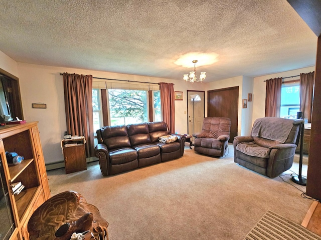 living room with carpet, a chandelier, a textured ceiling, and a healthy amount of sunlight