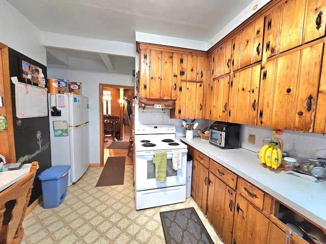 kitchen featuring ventilation hood and white appliances