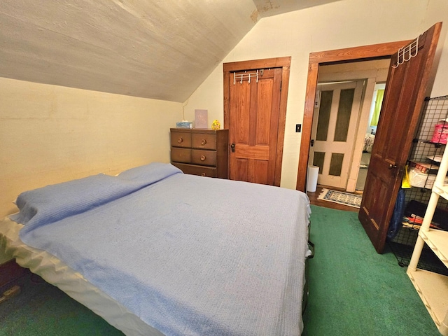 carpeted bedroom with lofted ceiling