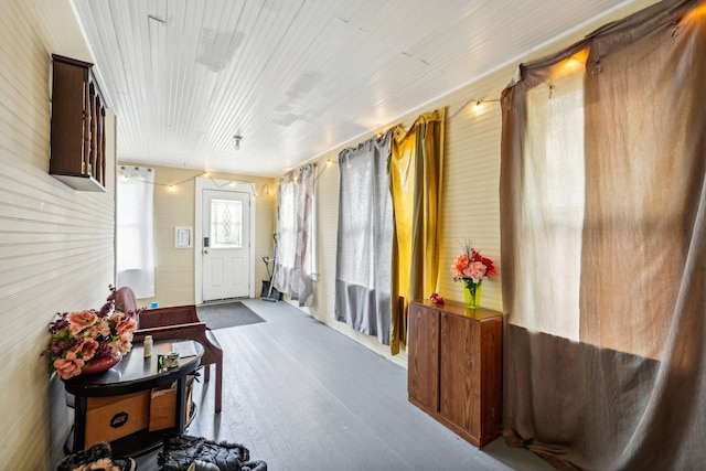 entryway with wooden walls and hardwood / wood-style floors