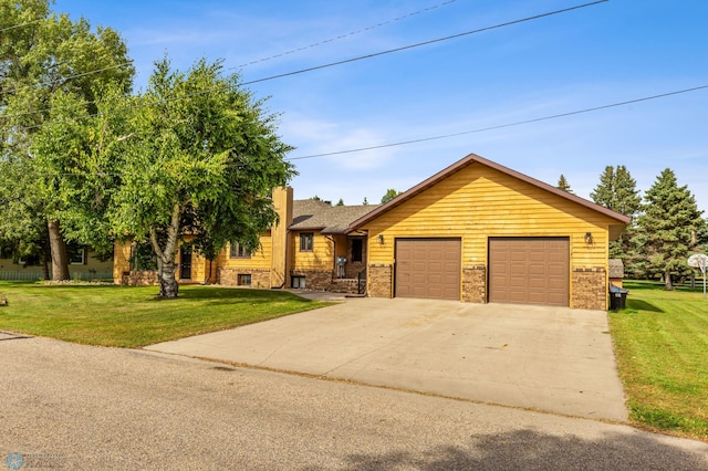 view of front of home with a garage and a front yard