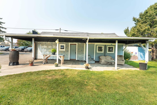 back of house featuring a patio and a yard