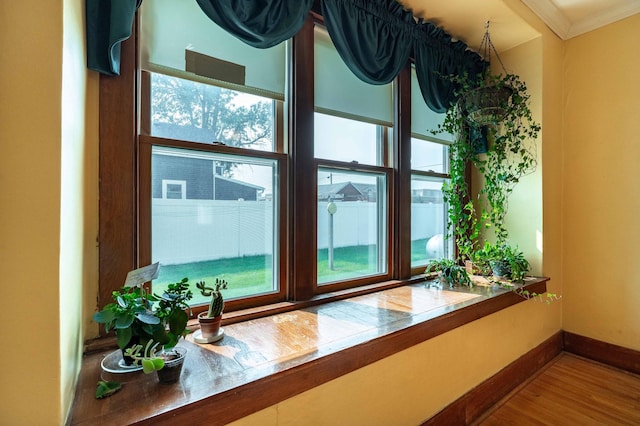 interior details featuring ornamental molding and hardwood / wood-style flooring