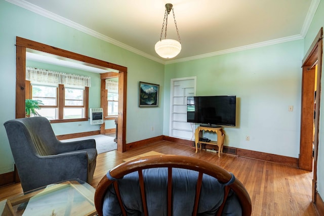 living room featuring heating unit, crown molding, and hardwood / wood-style floors