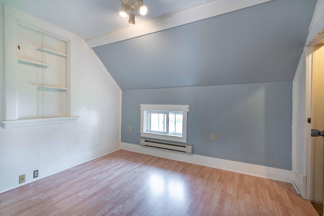 bonus room featuring a baseboard radiator, light wood-type flooring, and vaulted ceiling