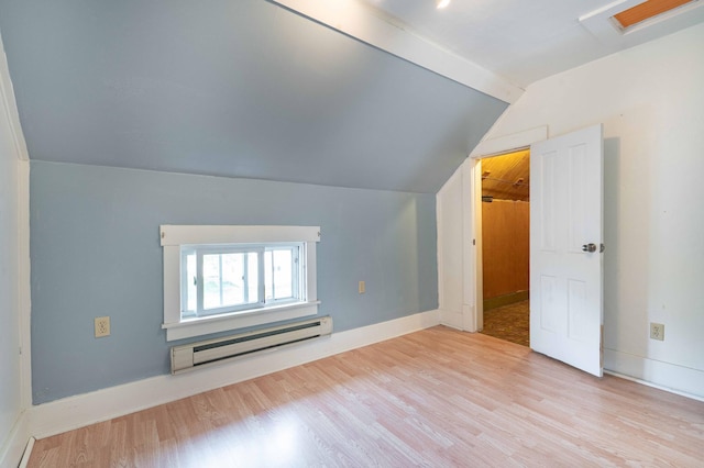 bonus room with light wood-type flooring, vaulted ceiling, and a baseboard heating unit