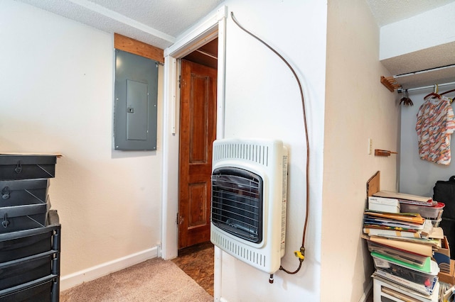 interior space featuring carpet floors, electric panel, heating unit, and a textured ceiling