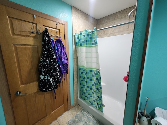 bathroom with tile patterned flooring and walk in shower