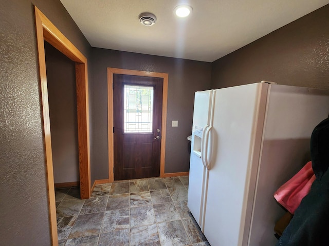 kitchen with white fridge with ice dispenser