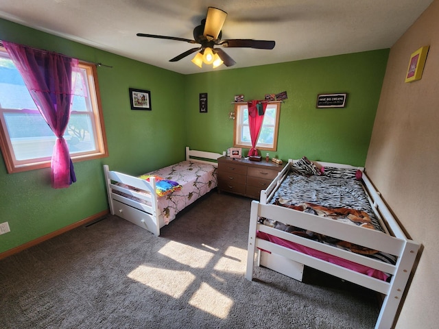 bedroom featuring dark colored carpet and ceiling fan