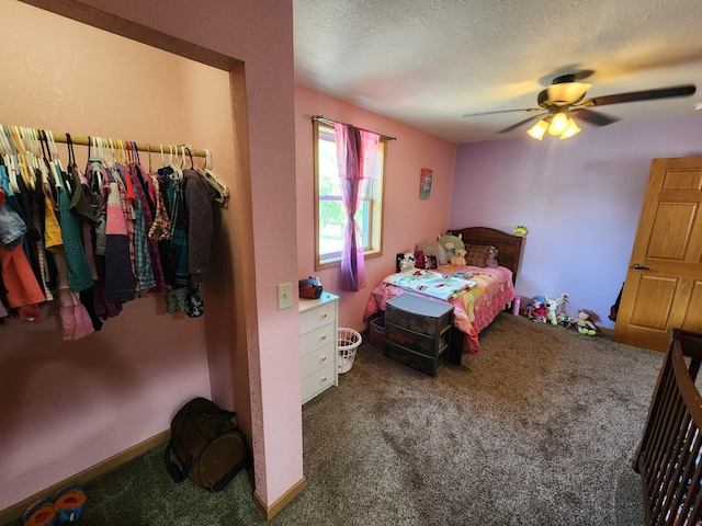 carpeted bedroom with ceiling fan and a textured ceiling