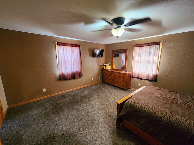 unfurnished bedroom featuring a textured ceiling, carpet, and ceiling fan