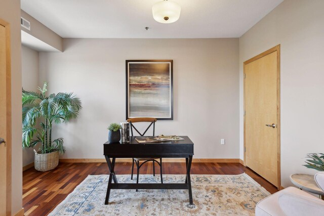 office area featuring baseboards and wood finished floors