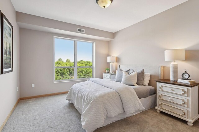 bedroom with carpet flooring, baseboards, and visible vents