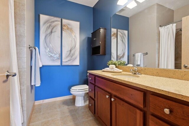 bathroom featuring tile patterned floors, visible vents, toilet, baseboards, and vanity