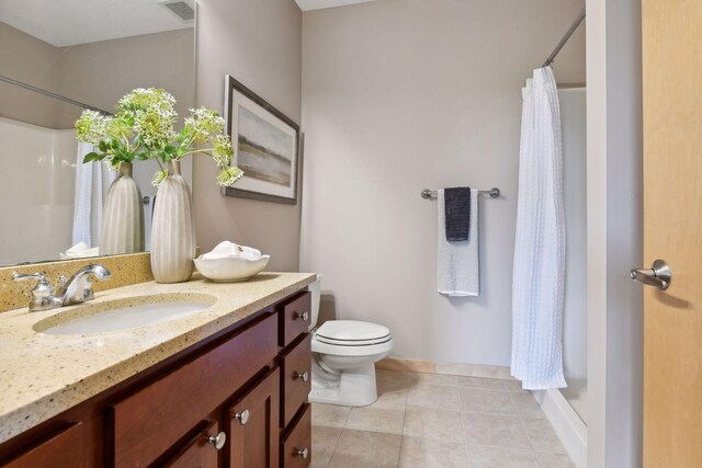 bathroom with vanity, visible vents, tile patterned flooring, curtained shower, and toilet