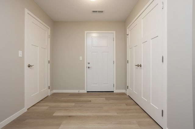 corridor with light hardwood / wood-style flooring