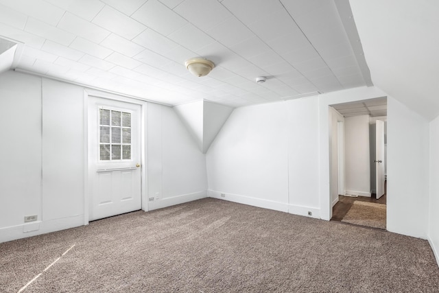 bonus room featuring carpet flooring and vaulted ceiling