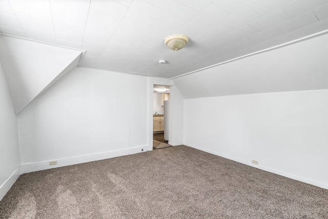 bonus room featuring carpet floors and lofted ceiling