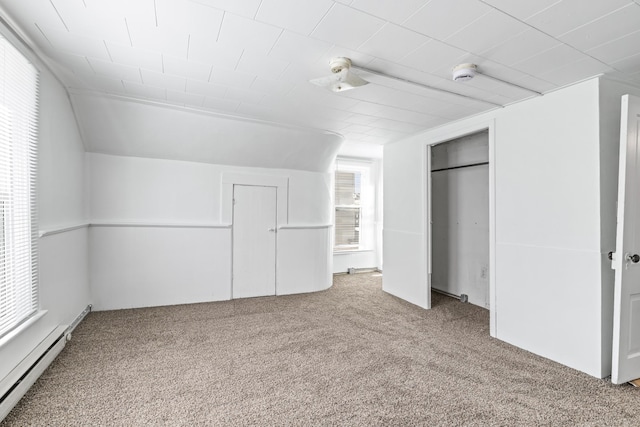 interior space with lofted ceiling, carpet, a closet, and baseboard heating