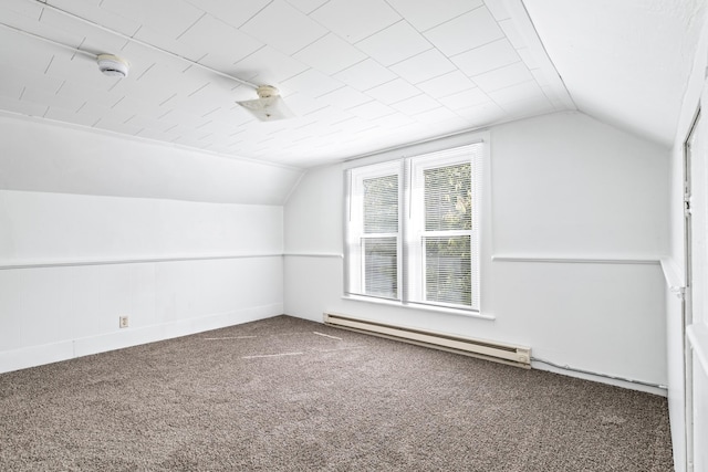 bonus room with a baseboard heating unit, lofted ceiling, and carpet flooring